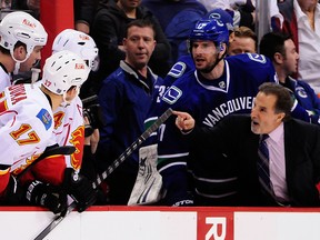 Vancouver Canucks head coach John Tortorella and forward Ryan Kesler talk to the Calgary Flames defenceman Shane O'Brien and forward Lance Bouma and Calgary Flames forward Jiri Hudler during the first period at Rogers Arena on Jan 18, 2014 in Vancouver, British Columbia. (Anne-Marie Sorvin/USA TODAY Sports)