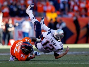 Broncos’ Terrance Knighton brings down Patriots QB Tom Brady on Sunday in Denver. (GETTY IMAGES)