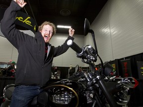 Bryce Morrison sits jubilantly on the new Triumph Bonneville T100 motorcycle he won from Echo Cycle and the Edmonton Sun during the final day of the Edmonton Motorcycle and ATV Show at the Edmonton Expo Centre on Sunday. (IAN KUCERAK/Edmonton Sun)