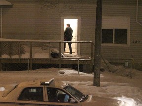 A police officer enters a multi-family residence on Andrews Street in Winnipeg, Man., on Sun., Jan. 19, 2014, where a suspicious death is believed to have taken place. (Kevin King/Winnipeg Sun/QMI Agency)