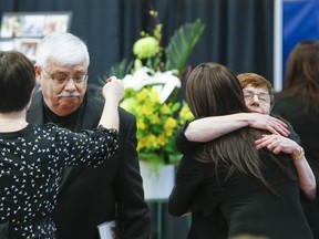 Ernest Doroszuk/QMI Agency
Reno Peloso (left) is comforted during a  memorial service for his son Christopher Peloso earlier this month in Toronto. On Saturday, a second memorial was held in Sudbury.