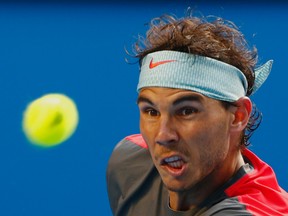 Rafael Nadal hits a return to Kei Nishikori during the Australian Open in Melbourne January 20, 2014. (REUTERS/Petar Kujundzic)