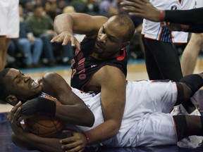 Bobcats small forward Michael Kidd-Gilchrist (left) calls a timeout while fighting for a loose ball with Raptors power forward Chuck Hayes during the first half for their game in Charlotte on Monday afternoon. (Jeremy Brevard/USA TODAY Sports)