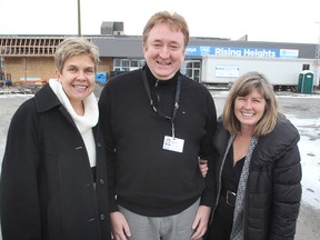 Kingston Community Health Centres' Sandy Sheahan, left, Stafford Murphy and Donna Glasspoole stand in front of their new building, currently under construction at the Weller Avenue plaza.
Michael Lea The Whig-Standard