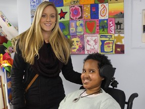 Hibaq Abdi, right, employs her personal care attendants, including seen Kara Messenger, left, under a provincial program that lets people with disabilities manage their care and live more independently. (DEBORA VAN BRENK, The London Free Press)