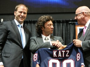 Patrick Laforge and Daryl Katz (centre) shake hands at the announcement of Katz's purchase of the team in 2008 as Kevin Lowe, then the team's GM, looks on. (Edmonton Sun file)