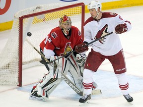 Phoenix Coyotes right winger David Moss (18) watches the puck deflect away from the goal on a shot against Ottawa Senators goalie Craig Anderson (41) in the third period at the Canadian Tire Centre on Dec. 21, 2013. (MARC DESROSIERS/USA TODAY Sports)