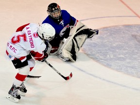 Liam Raymond, of the Schumacher Praztek Nailers, fi res a wrist shot past Cochrane CGV Builders goalie Cody Girard for one of his two goals in the Atom Division championship game at the Panels and Pipes Winter Classic Tournament at the Archie Dillon Sportsplex on Sunday. Cochrane defeated Schumacher 8-6. Photo by Thomas Perry