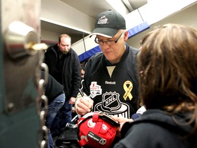 Former NHL player Dennis Maruk signs an autograph in this file photo. Maruk is set to visit the St. Thomas Sports Spectacular this week.