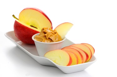 Small apple, sliced with 1 Tbsp. natural almond butter. (William Berry/Fotolia)