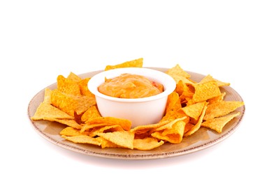 1/2 small whole grain tortilla cut into wedges, topped with 1 Tbsp. grated cheese. Heat in microwave to melt cheese; top with 1 Tbsp. salsa. (Ruzanna Arutyunyan/Fotolia)
