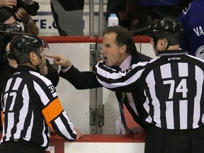 Vancouver Canucks’ head coach John Tortorella (centre) screams at the Calgary Flames bench during the first period of NHL game at Rogers Arena in Vancouver, B.C. on Saturday January 18, 2014. Carmine Marinelli/Vancouver 24hours