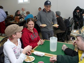 Kingston and the Islands Member of Parliament Ted Hsu played waiter and delivers meals to clients Kristine Bedard (left), Chantelle Vankoughnett, Tim Martineau and Simon Letourneau during the lunch program at St. Vincent de Paul on Tuesday.
IAN MACALPINE/KINGSTON WHIG-STANDARD/QMI AGENCY