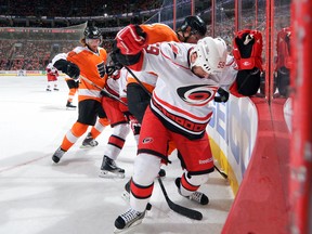 Braydon Coburn and Chad LaRose  battle along the boards at the Wells Fargo Center on February 9, 2013 in Philadelphia, Pennsylvania. (Drew Hallowell/Getty Images/AFP)