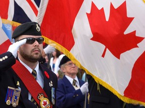 Royal Canadian Legion Branch 52 Color Sgt. David Dodd salutes during the playing of the Last Post at the Remembrance Day Service on Nov. 11, 2012 at the Peterborough Cenotaph in Confederation Square. Other soldiers are questioning the stories he has told about serving with Princess Patricia's Canadian Light Infantry and why he is wearing medals without having served in duty. Branch 52 is conducting an investigation. 
Clifford Skarstedt/Peterborough Examiner/QMI Agency file photo