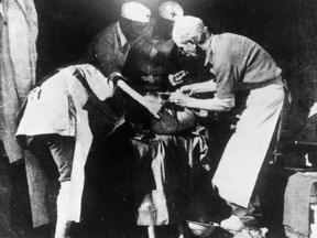 Dr. Bethune performing surgery in an unused temple in Hopei, China in 1939. 
National Film Board/Library and Archives Canada