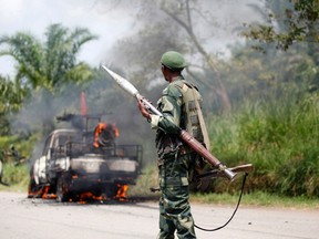 A Congolese soldier from the Armed Forces of the Democratic Republic of Congo (FARDC) looks at their burning vehicle after an ambush near the village of Mazizi in North Kivu province on Jan. 2.
REUTERS/QMI Agency