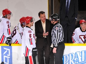 Vikings coach Blaine Gusdal is shown in conversation with an official and defenceman Harrison Tribble, No. 6. (Supplied)