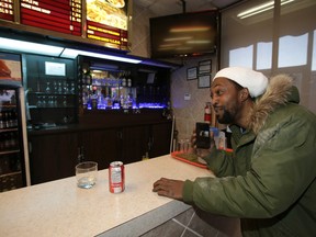 Dwight Baynes listens to a video of Mayor Rob Ford inside the Steak Queen diner where it was shot the night before, on Tuesday, January 21, 2014. (Craig Robertson/Toronto Sun)