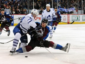 Toronto Maple Leafs defenceman Morgan Rielly and Colorado Avalanche center John Mitchell battle for control in the second period in Denver on Tuesday night. The Leafs won 5-2. (Ron Chenoy-USA TODAY Sports)