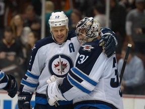 Jan 21, 2014; Anaheim, CA, USA; Winnipeg Jets center Olli Jokinen (12) celebrates with goalie Ondrej Pavelec (31) after the game against the Anaheim Ducks at Honda Center. The Jets defeated the Ducks 3-2. Mandatory Credit: Kirby Lee-USA TODAY Sports
