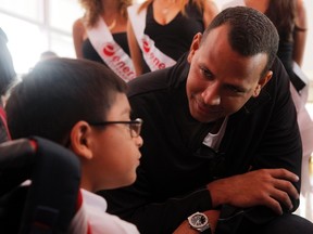 Suspended Yankees third baseman Alex Rodriguez talks with a disabled child during his visit at the Children's Rehabilitation Center Teleton in Cancun, Mexico on Jan. 16, 2014. (Victor Ruiz Garcia/Reuters)