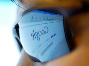 A Chinese Internet user browses for information on the popular search engine Google in Beijing in this file photo. REUTERS/Andrew Wong/File photo