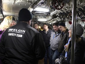Submariner Dean Lewis has the rapt attention of his tour group as he explains operations in the Control Room aboard HMCS Ojibwa, a Cold War submarine and the first exhibit of The Museum of Naval History at Port Burwell.