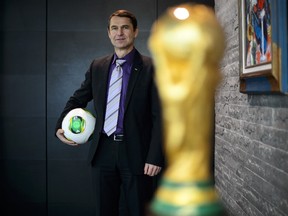 FIFA's head of security, Ralf Mutschke, poses next to the World Cup trophy during an interview on January 15, 2013 at the FIFA headquarters in Zurich. (AFP PHOTO / FABRICE COFFRINI)