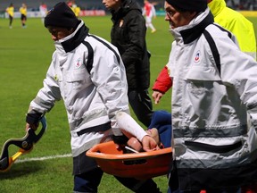 Monaco's Colombian forward Radamel Falcao (C) is lifted away from the pitch after being injured during the French Cup football match between Chasselay (MDA) and Monaco (ASM) on January 22, 2014 at the Gerland stadium in Lyon, central-eastern France.  (AFP)