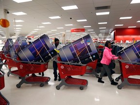 Thanksgiving Day holiday shoppers line up with television sets on discount at the Target retail store in Chicago, Illinois in this November 28, 2013 file photo. (REUTERS/Jeff Haynes/Files)