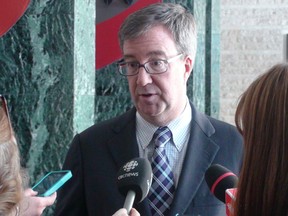 Mayor Jim Watson speaks with reporters after a council meeting, during which he delivered his annual state of the city address on Wednesday, Jan. 22, 2014. Jon Willing/Ottawa Sun/QMI Agency