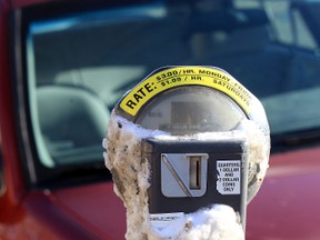 A parking metre is seen with frozen ice and snow covering it in front of the Edmonton Police Service headquarters in downtown Edmonton on Nov 4, 2013. Someone had chipped some of the ice off so people could spill put there money in. Tom Braid/Edmonton Sun/QMI Agency