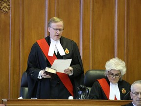 Gino Donato/The Sudbury Star
The Honourable Justice Robbie Gordon reads the oath of office as he is sworn in as the new Regional Senior Justice for the North East Region. Administering the oath is The Honurable Chief Justice Heather Smith at right. Gordon replaces the Honourable Madam Justice Louise Gauthier, whose term ended.