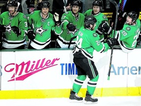 Dallas Stars defenceman Jordie Benn is congratulated by teammates, including brother Jamie (left), after scoring a penalty-shot goal against the Minnesota Wild on Tuesday night. (GETTY IMAGES)