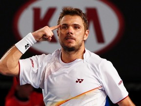 Stanislas Wawrinka celebrates after defeating Tomas Berdych in their men's singles semifinal at the Australian Open in Melbourne January 23, 2014. (REUTERS/Petar Kujundzic)