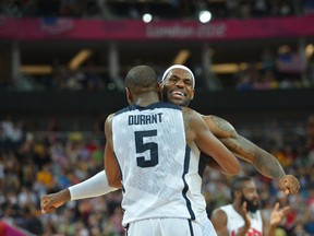 LeBron James and Kevin Durant of the U.S. Men's Senior National Team celebrates against Spain during their Men's Gold Medal Basketball Game on August 12, 2012 in London, England. (Jesse D. Garrabrant/NBAE via Getty Images/AFP)