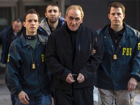 Bonanno crime family leader Vincent Asaro is escorted by FBI agents from their Manhattan offices in New York January 23, 2014. REUTERS/Brendan McDermid