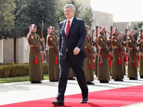 Canada's Prime Minister Stephen Harper walks after reviewing Bedouin honour guards during his visit to Jordan at the Royal Palace in Amman January 23, 2014. REUTERS/Muhammad Hamed