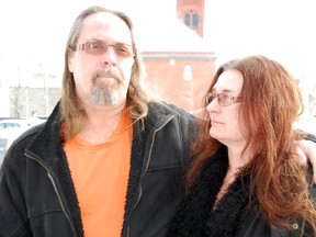 Downtown business owner Jim Bender stands with his partner Angie Bender oustide the Sentinel-Review office Thursday, Jan. 23, 2014, a day after he was arrested for trafficking marijuana. Jim Bender admits to selling the drug but said he did it so he could pay for his severely autistic's son respite care after he had funding cut this past summer. (TARA BOWIE, Sentinel-Review)