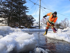 Loyalist Township employee Shawn Seymour shovels ice from Gore Street in Odessa Thursday afternoon as the Millhaven Creek floods properties in the town.
Elliot Ferguson The Whig-Standard