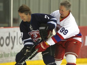 Jim Cuddy (left), of Blue Rodeo, skates with former NHL player Perry Miller, at the MTS Iceplex.  Thursday, January 23, 2014. (Chris Procaylo/Winnipeg Sun/QMI Agency)