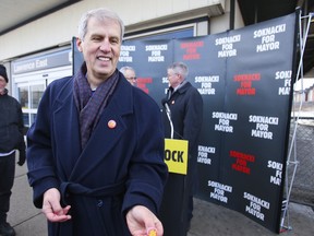 Toronto mayoral candidate David Soknacki poses with campaign buttons outside of Lawrence East SRT Station in Toronto Tuesday, January 14, 2014. (Ernest Doroszuk/Toronto Sun)