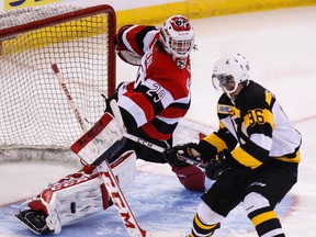 Ottawa 67's goaltender Philippe Trudeau makes a save against Kingston Frontenacs' Spencer Watson during OHL action at the Canadian Tire Centre in Ottawa  Wednesday night. Kingston won 6-4 to snap a five-game losing streak. (Errol McGihon/QMI Agency)