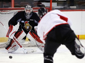 Ottawa Senators' goalie Robin Lehner (40) eyes a shot from Matt Kassian (28) during team practice at Canadian Tire Centre on Friday January 17, 2014. The Senators welcome the New York Rangers Saturday. Darren Brown/Ottawa Sun/QMI Agency