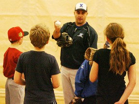 Chris James explains the proper mechanics in gripping and throwing a baseball to the young ball players on hand at the first indoor clinic put on by the Stony Plain Amateur Minor Ball Association on Jan. 13. - Gord Montgomery, Reporter/Examiner
