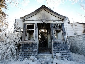 What is left of this home at 191 Queen St. in Tyendinaga Township, Ont. sit in an icy pile of rubble Friday morning, Jan. 24, 2014 after it was destroyed by fire Thursday evening, Jan. 23, 2014. - JEROME LESSARD/The Intelligencer/QMI Agency