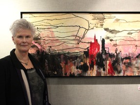 Jean Blackall stands with one of her favourite pieces of “Urban Re-Visited,” her collection of collages showcased at the Allied Arts Council in Spruce Grove until Feb. 1. - Karen Haynes, Reporter/Examiner