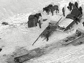 A recovery crew surrounds a hole in the ice along the ice bridge that connected Wolfe Island to the mainland in Kingston in 1984. One Jan. 15 that year three members of the Murphy family were killed when their car broke through the ice.