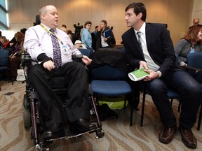 EPS acting Detective Bryce Clarke and Mayor Don Iveson take part in a press conference for the City of Edmonton's Measuring Up initiative, at City Hall in Edmonton, Alta., on Friday Jan. 24, 2014. The initiative aims to change attitudes around the needs of persons with disabilities. David Bloom/Edmonton Sun
